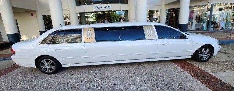 White 9 seater Limo outside of the Oaks