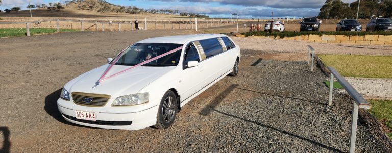 white 9 seater limo ready to drive the wedding guests