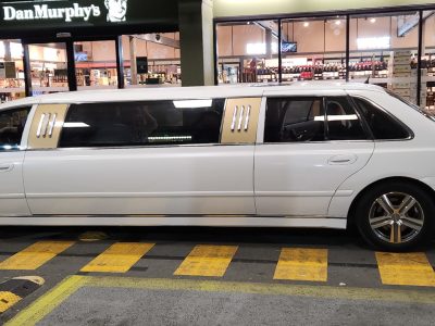9-seater limo with shimmering white sheen paint with gold trims