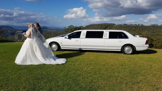 A photo of one of our limousines by a gorgeous outdoor Wedding