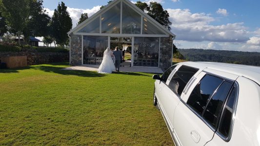 A photo of one of our limousines by a gorgeous Wedding ceremony