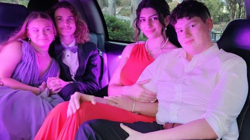 Four youths, smartly dressed inside our limo going to their School Formal